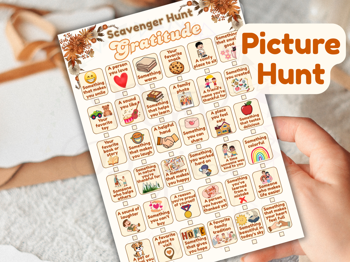 Scavenger hunt gratitude picture hunt sheet held by a hand on a light background